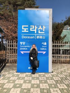 Girl in front of sign at Dorasan Train Station